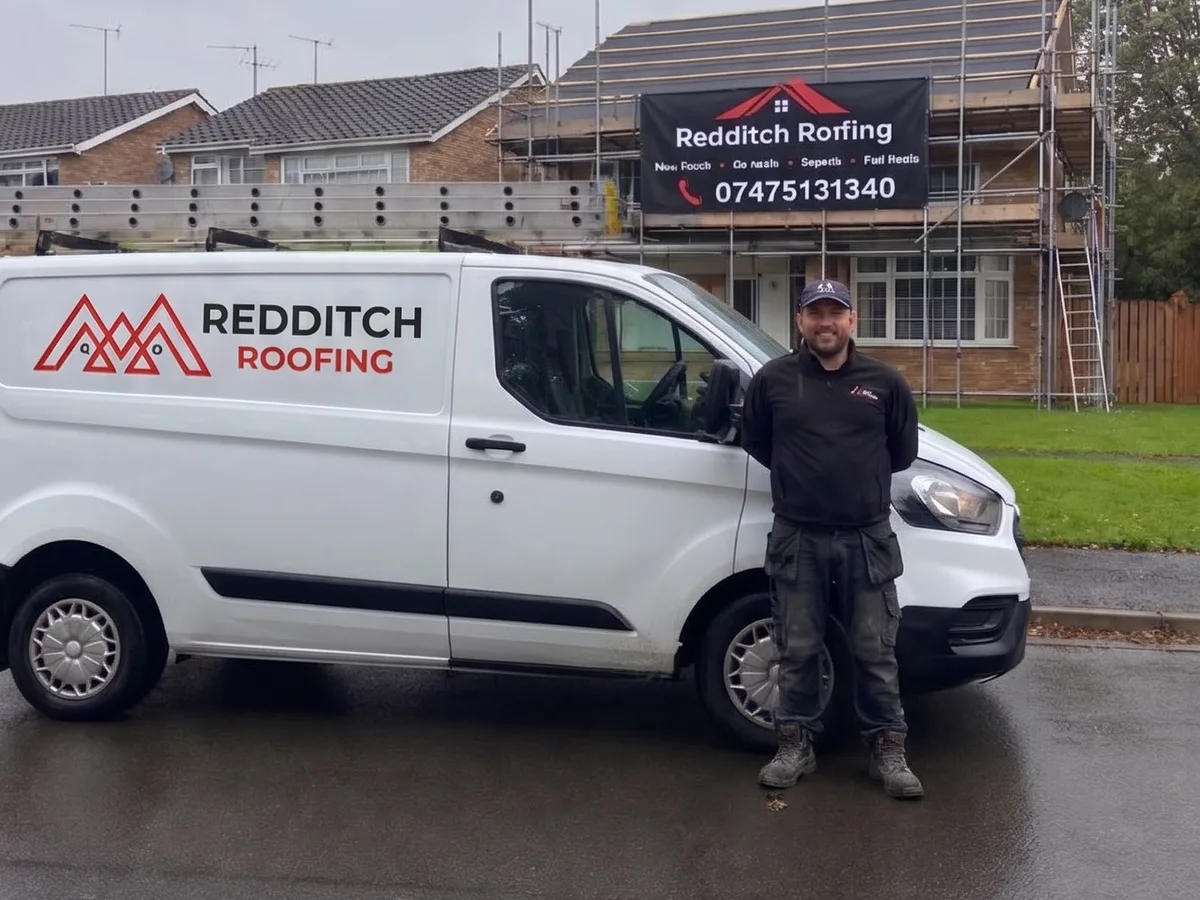 James Freeman standing by the Redditch Roofing van in front of a scaffolded re-roof